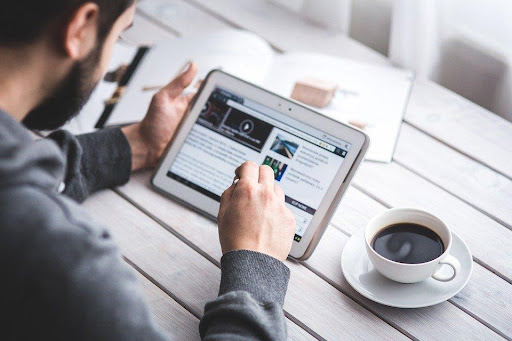 Man reading an article on a tablet
                                            