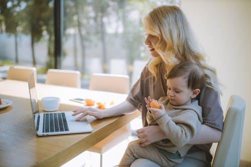Accounting professional Woman working from home with baby in lap
