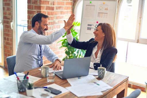Two-Colleagues-High-Fiving Two Colleagues High Fiving Each Other